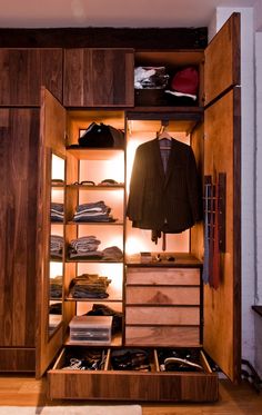 an open closet with clothes and shoes in it