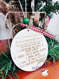 a christmas ornament hanging from the top of a tree with ornaments around it