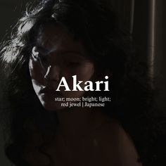 a woman with long dark hair and the words akari written in white on her face