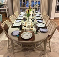 a dining room table set with plates and place settings for six people to eat at