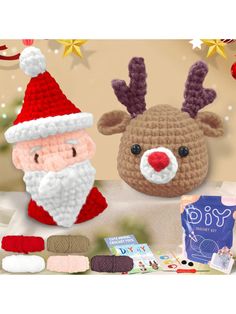 two crocheted santa claus and reindeer hats on a table with other christmas items