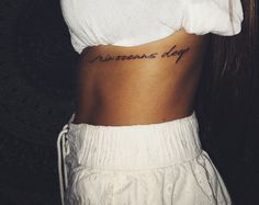 a woman's stomach with the words awesomeness day tattooed on her lower back