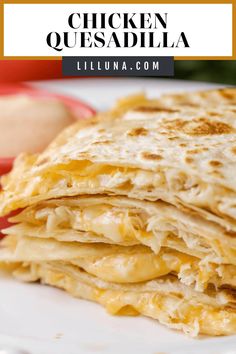 chicken quesadilla on a white plate with an apple in the background