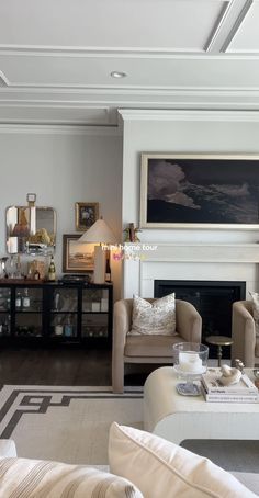 a living room filled with furniture and a fire place in front of a painting on the wall