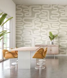 a modern dining room with an abstract wallpaper