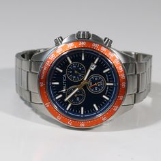 Item No. NAPOBF117 Nautica Men's Blue Dial Stainless Steel Blue Dial Chronograph Watch NAPOBF117 Watch Features: Quartz Movement Stainless Steel Case Stainless Steel Bracelet Chronograph Function Blue Dial Orange Fixed Bezel Analog Display Date Display Luminous Hands Luminous Markers Tachymeter Water Resistance: 100 Meters Case Diameter: 47mm Case Thickness: 13mm Lug Width: 22mm Butterfly Deployant Clasp Mineral Crystal Free Priority Shipping on all orders in continental U.S. Shipping time is usually between 2 and 6 day's. 1 day handling time. About Us We are a new company and we hold ourselves to a higher standard than the typical seller. We Pride Ourselves in offering only new Authentic watches. All watches come new with box and papers. We offer some of the best pricing in the watch indu Luxury Blue Chronograph Watch With Round Dial, Blue Stainless Steel Chronograph Watch With Tachymeter, Blue Stainless Steel Chronograph Watch, Blue Water-resistant Watch With Round Dial, Blue Diving Watch With Round Dial, Orient Watch, Swiss Military, Authentic Watches, Sports Models