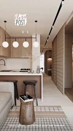 a living room filled with furniture next to a kitchen