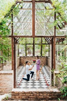 an engaged couple dancing in the greenhouse at their wedding