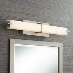 a bathroom light that is on above a mirror