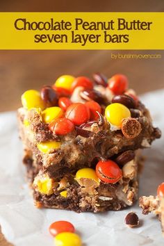 chocolate peanut butter seven layer bars with m & m candies on top and the title above it reads, chocolate peanut butter seven layer bars