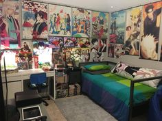 a bedroom with anime posters on the wall and a bed in front of a desk