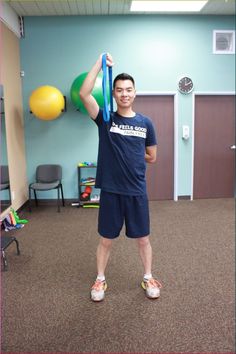 a man is holding some balloons in his hand