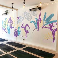 the wall is painted with colorful designs on it's sides and features yoga figures