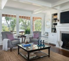 a living room filled with furniture and a flat screen tv mounted on the wall above a fireplace