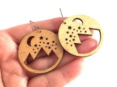 These beautiful natural mountain landscape laser cut wood earrings make a statement!  Perfect to go with any outfit. The hoop shapes are laser cut out of lightweight wood and measure 40mm by 40mm. You can choose surgical stainless steel hooks or solid sterling hooks. Laser Cut Wood Jewelry, Natural Mountain, Mountain Earrings, Laser Cut Wood Earrings, Laser Cut Wood, Wood Earrings, Wood Jewellery, Mountain Landscape, Earrings Dangle