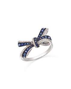 a white gold ring with blue and white diamonds on the side, set in 18k white gold