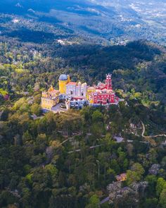 an aerial view of a large building in the middle of trees