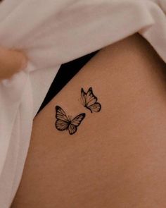 two butterflies on the back of a woman's stomach