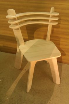 a white wooden chair sitting on top of a floor