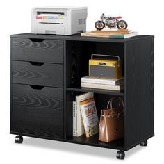 a black bookcase with drawers and a printer on top