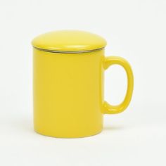 a yellow coffee cup with a lid on a white background