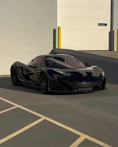 a black sports car parked in front of a building