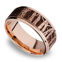 a wedding band with an etched design in rose gold and white gold, is shown