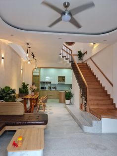 a living room filled with furniture and a staircase