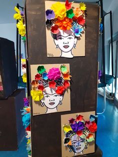 some paper flowers are placed on top of a cardboard board that is made to look like a woman's head