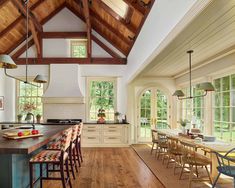 a large kitchen with wooden floors and vaulted ceiling, along with an island countertop