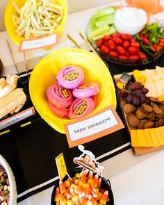 a table topped with lots of different types of foods and desserts on top of it