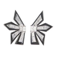 One of its kind earrings crafted in 18kt white gold. This pair of dynamite earrings are handmade with trillion & baguatte cut diamonds with each diamond recut to bring this fire. Each spoke is tipped with glossy black enamel to highlight the precious diamonds. This striking shape is inspired by post modern architecture. We have used 1.08 carats of natural diamonds Luxury Trillion Cut Diamond White Jewelry, Fine Jewelry With Trillion Cut In White, Luxury White Trillion Cut Jewelry, Luxury Silver Enamel Earrings, Art Deco Diamond Jewelry With Black Enamel, Luxury Diamond-cut Diamond Linear Earrings, Post Modern Architecture, Post Modern, Earring Crafts