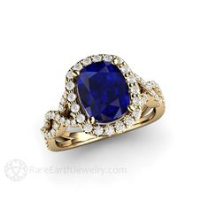 an oval shaped blue sapphire and diamond engagement ring with two rows of diamonds around the band