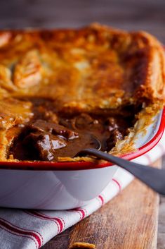 a close up of a casserole on a wooden table