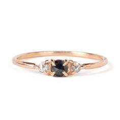 a black diamond ring with three diamonds on it