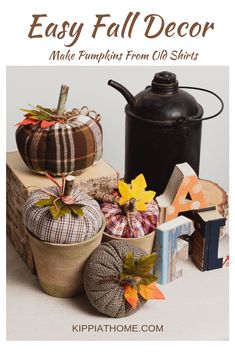 pumpkins and other fall decorations sit on top of a pile of books, next to a black teapot