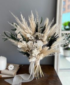 a bouquet of flowers sitting on top of a wooden table