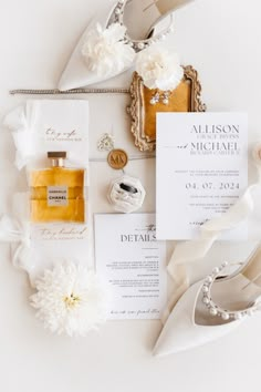 the wedding stationery is laid out on top of each other, including an envelope and matching shoes