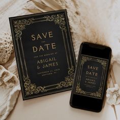 an image of save the date cards and phone on a furnishing area with feathers