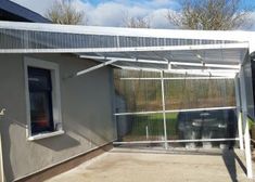 a house with a metal roof and white walls