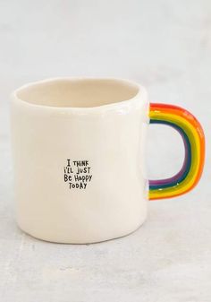 a white coffee mug with a rainbow handle and the words i think i'll just be happy today written on it