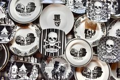 black and white plates with skulls on them are arranged in a pattern, as well as an image of a skeleton