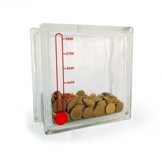 a clear plastic container filled with coins and a measuring scale