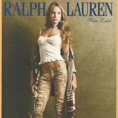 a magazine cover with a woman in ripped jeans and a white tank top standing on a brown background