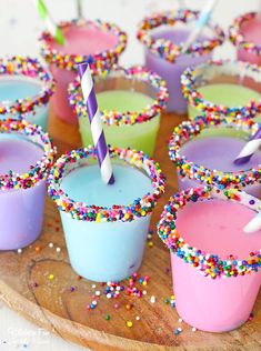 cupcakes with candles and sprinkles on a wooden tray