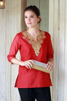 This stunning poppy-red tunic is the creation of Isha Jain in India. Crafted of a cotton/silk blend the neckline and cuffs of the tunic feature gold and silver gota embroidery an applique-like technique that originated in Rajasthan and is traditionally used on wedding and formal garments. Gold zari embroidery sequins and sparkling faux stones add extra glamour. The semi-sheer tunic features three-quarter length sleeves and a cotton-lined bodice.