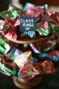 there is a sign that says class rings of 2013 on top of some candy bars