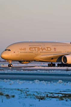 an airplane is sitting on the runway in the snow