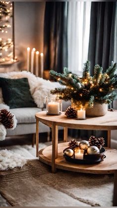 a living room with christmas decorations and candles on the coffee table in front of it