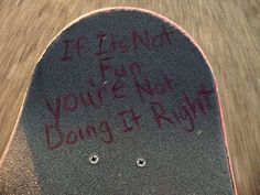 a skateboard with graffiti written on it